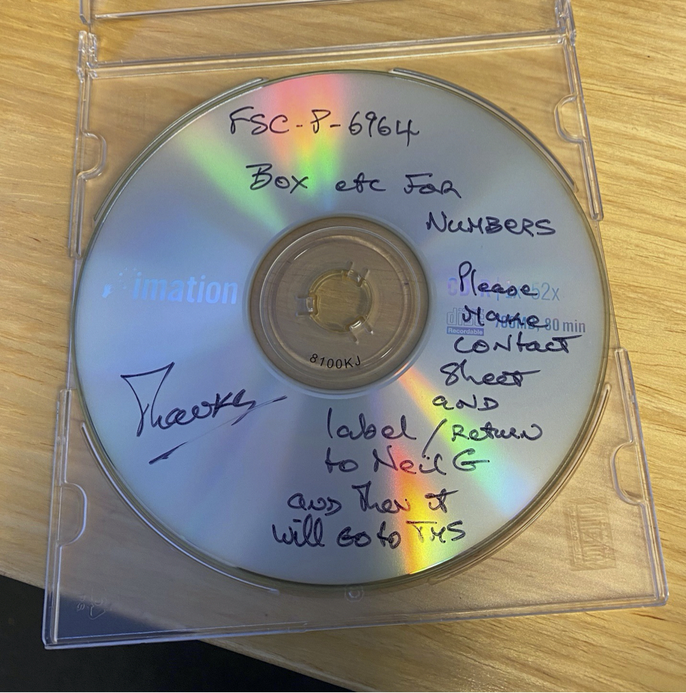 A CD from a recent collection with a detailed ink-written label. This information is recorded in the Archives’ Collection Management System (CMS). CD with an ink-written black label.