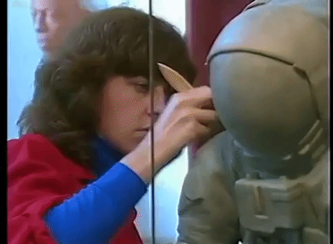In “The Smithsonian's Model Shop," an episode of Here At The Smithsonian that aired in 1985, Lora Moran discussed the process of recreating the moment man first stepped on the moon. Smithsonian Institution Archives, Accession 00-132, Volume 4, Episode 2. Moran uses a paintbrush on a model of a person in a spacesuit.