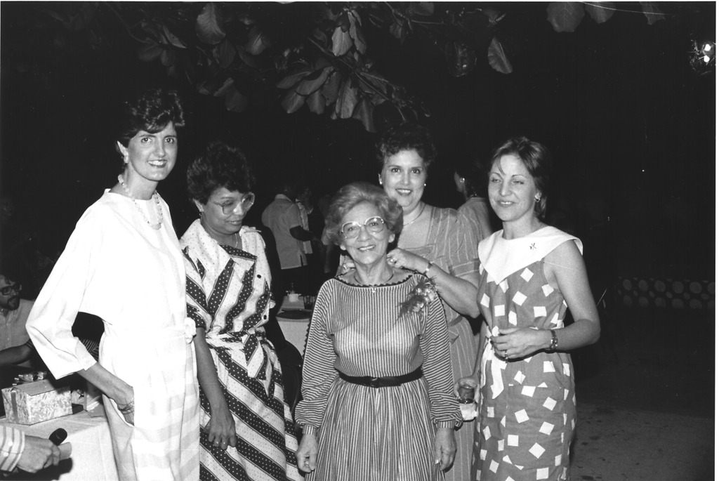 Adela Gómez’s retirement pary in 1984. Adela Gomez (center) is surrounded by the women she hired and mentored, (left to right) Elena Lombardo, Mercedes Arroyo, Gloria Maggiori, and Georgina De Alba, 1984, Courtesy of STRI. Adela Gómez standing in the center of a group of women outdoors underneath a tree.