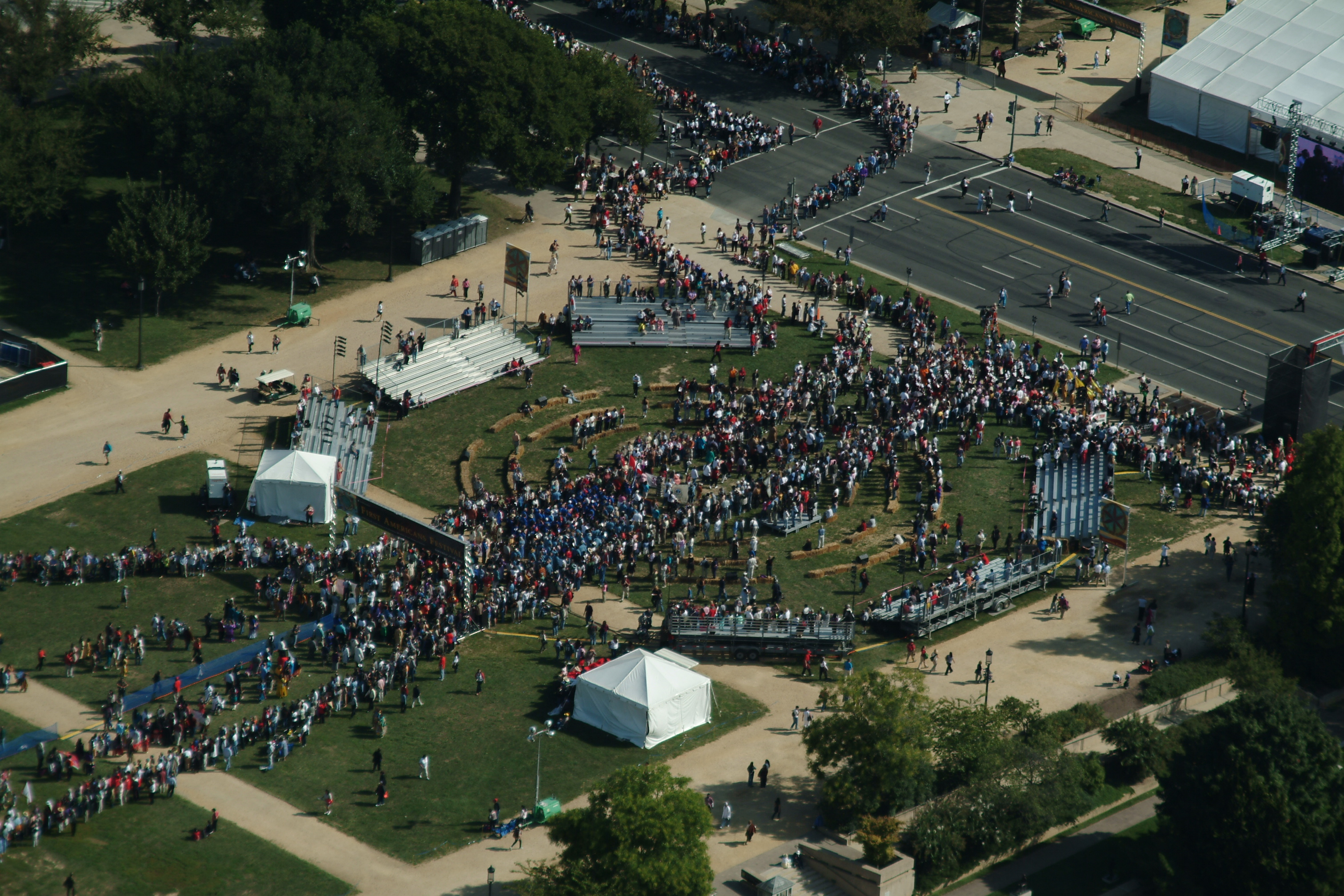 Aerial view of a crowd of people walking in lines on the National Mall.