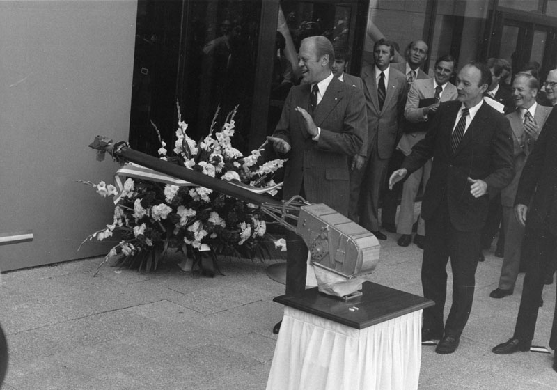 President Gerald Ford and Michael Collins watch the Viking impulse cut the ribbon at opening ceremony for the new building. Smithsonian Institution Archives, Record Unit 371, Box 2, Folder August 1976.