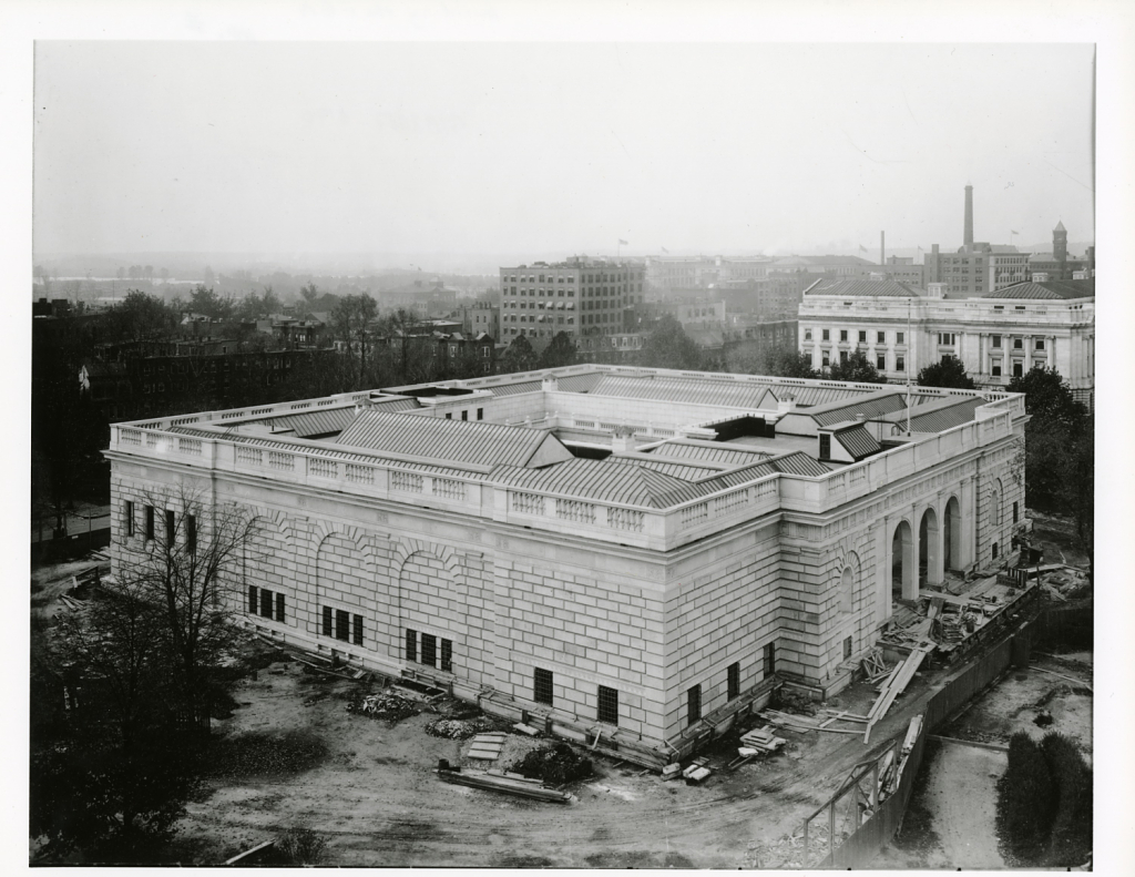 An aerial view of the north and east sides fronts of the Freer Gallery of Art shows construction debris on the ground.  Smithsonian Institution Archives, Collection 02-082, Box 2, Folder Photographs, Exterior - North Front.