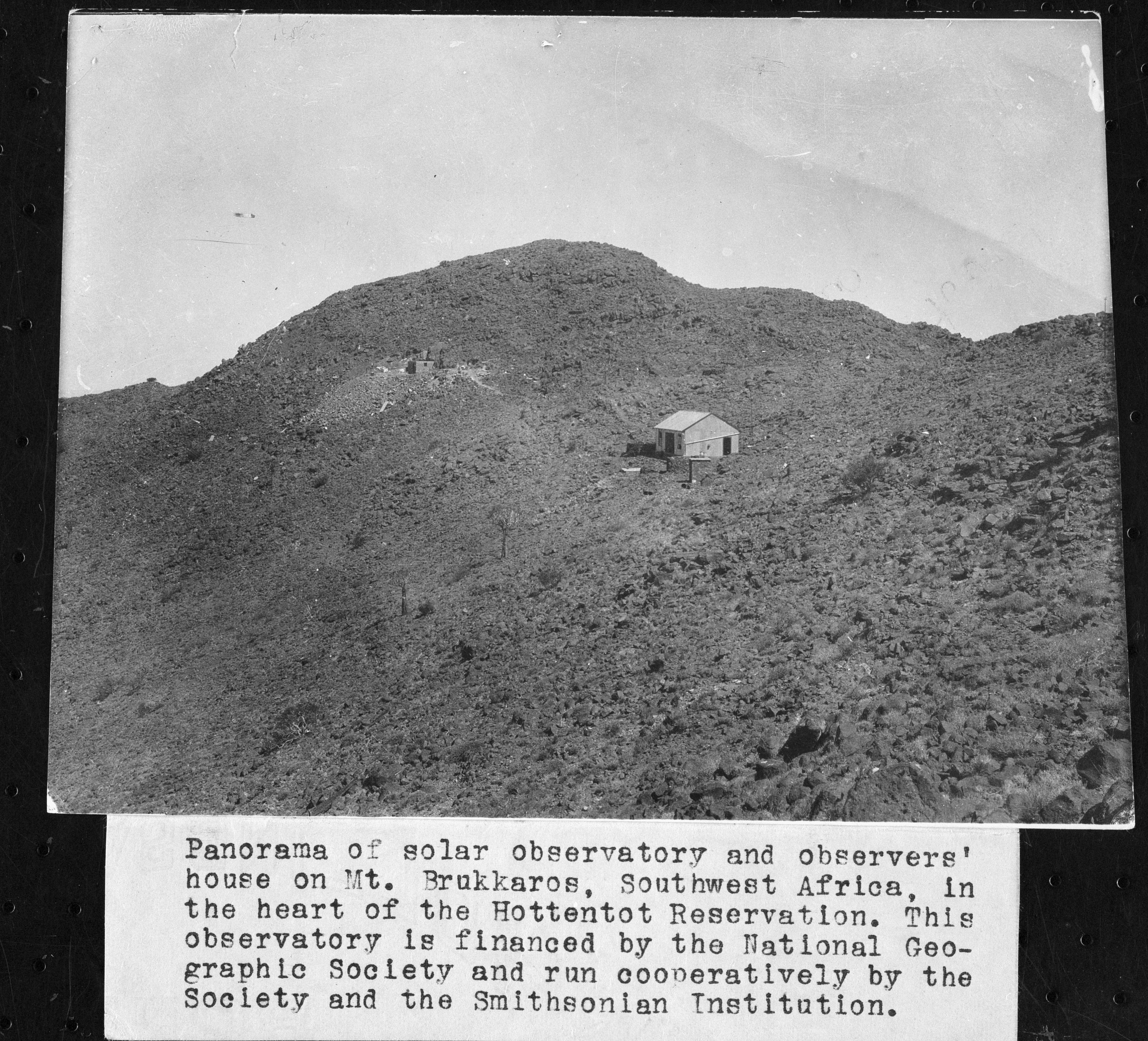 View of a structure on a mountain. The caption below the photograph reads: "Panorama of solar observ