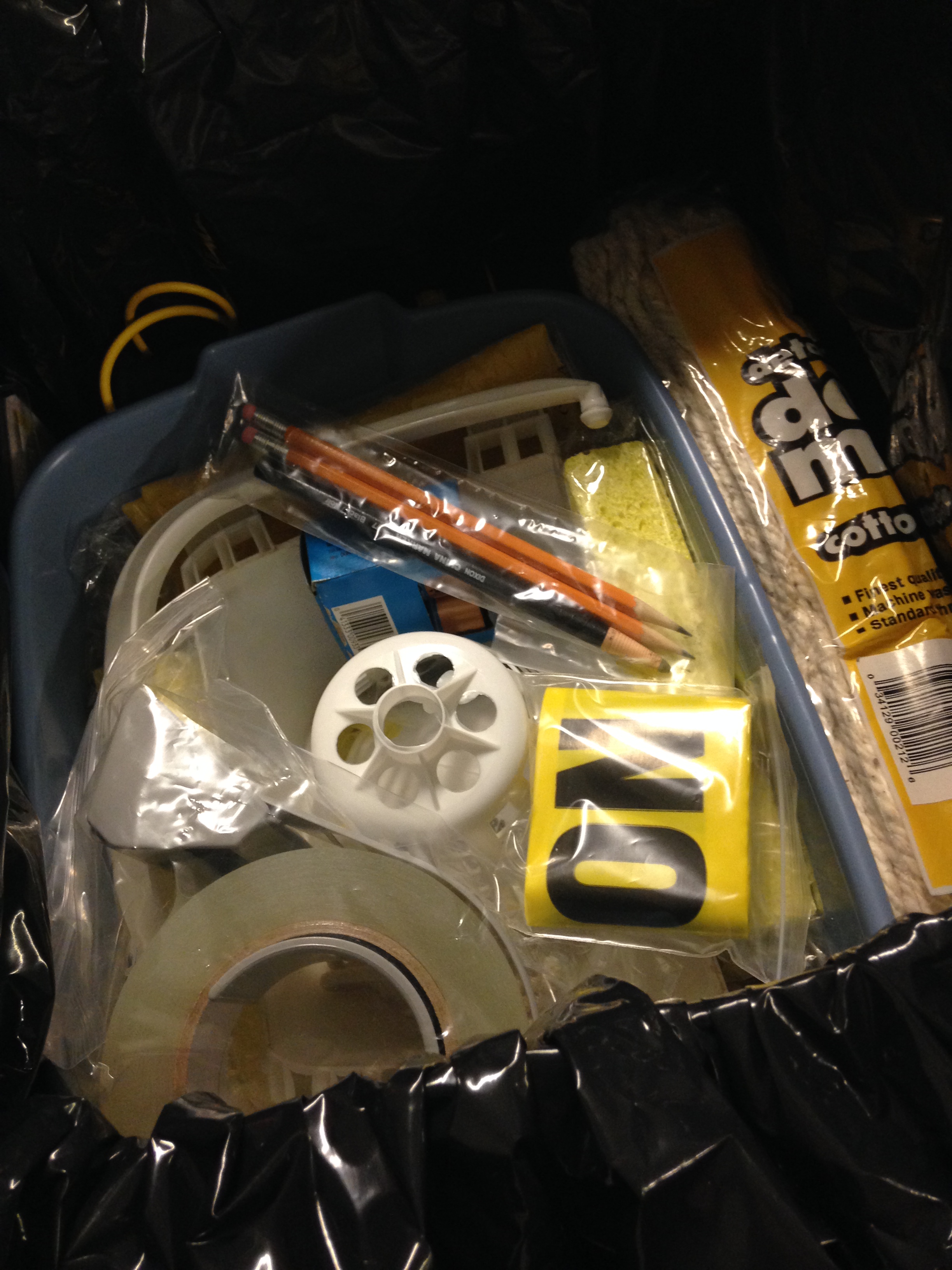 Box containing flashlights, batteries, nitrile gloves, spill pillows, absorbent paper, clipboards, p