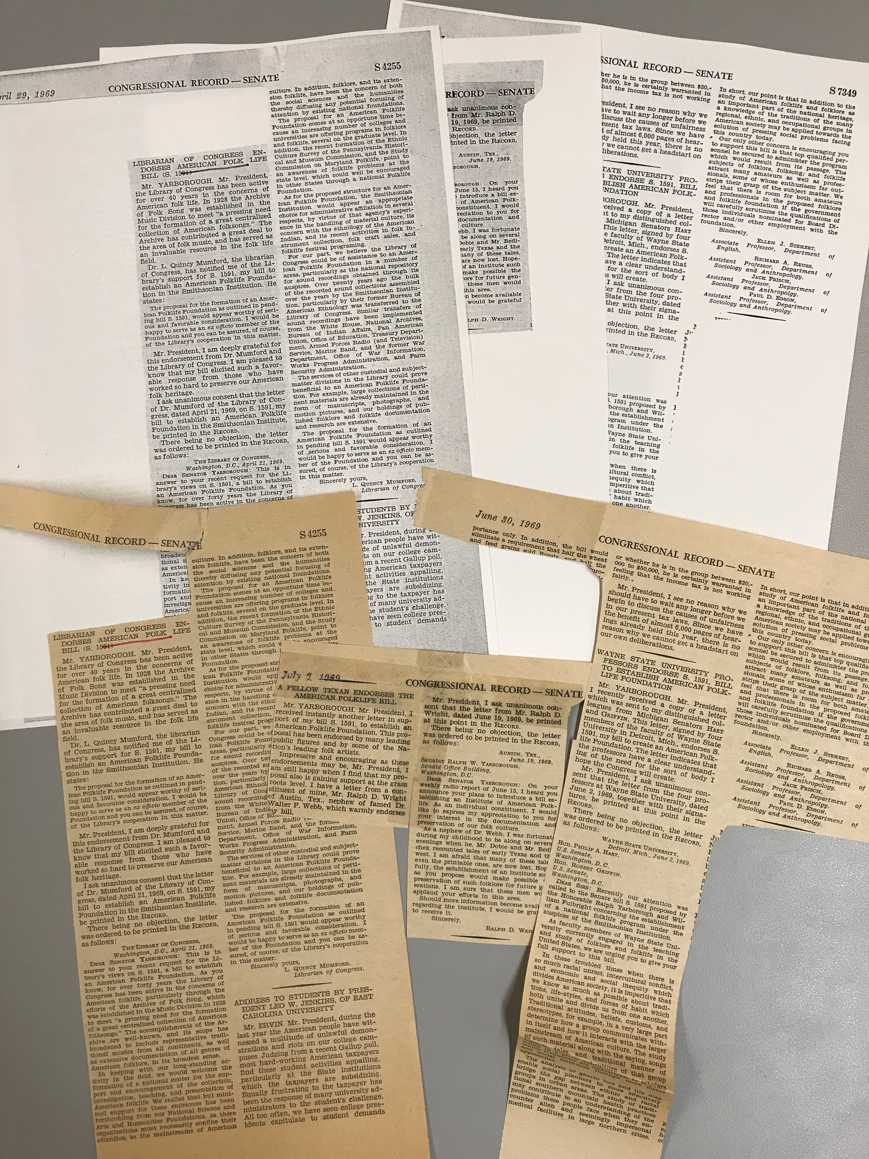 Original news clippings in front of preservation photo copies