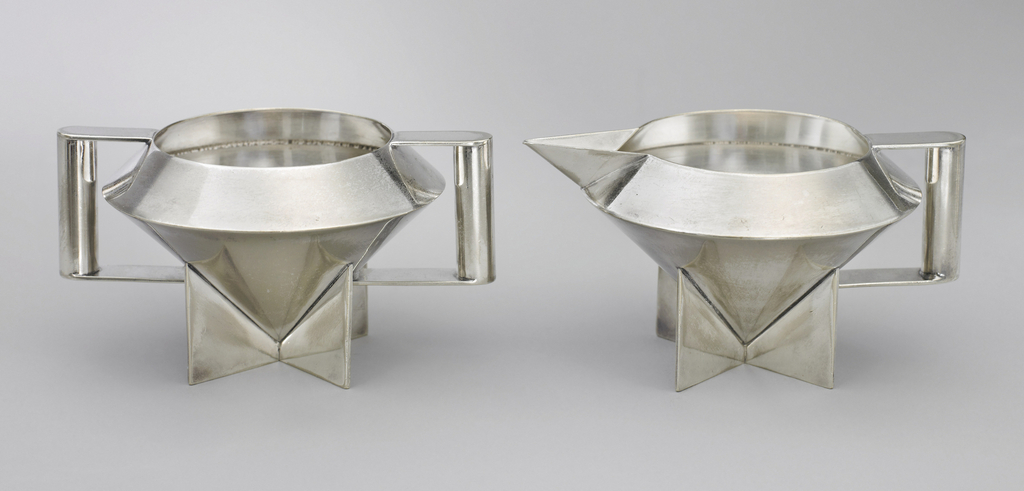 2 geometric silver vessels, one with handles on each side, one with a spout and handle