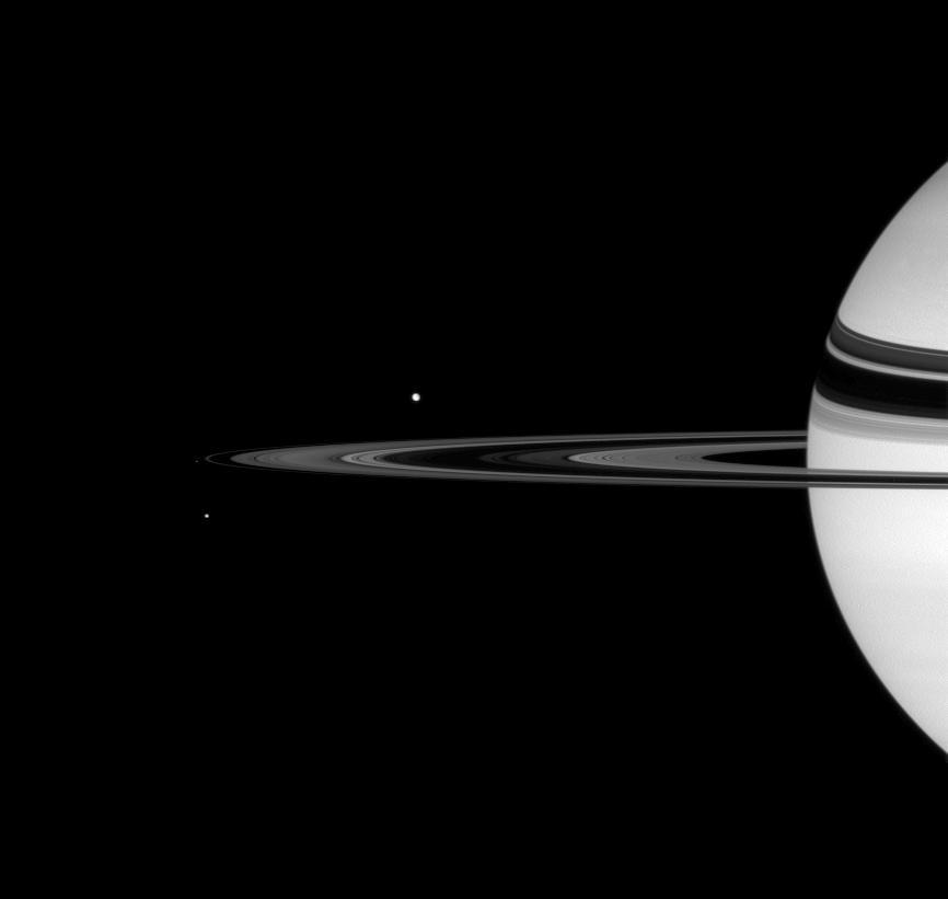 2 bright spots of light near 1/4 view of Saturn 