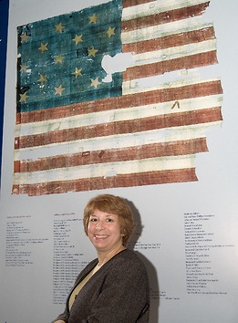 Zoidis stands in front of a Star-Spangled Banner exhibit.