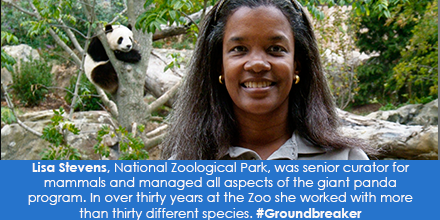 Women smiling at camera with a Giant Panda in the background to her right.