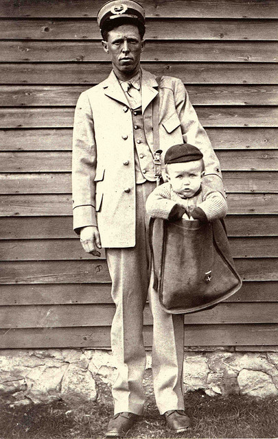 Uniformed Letter Carrier with Child in Mailbag, Unidentified photographer