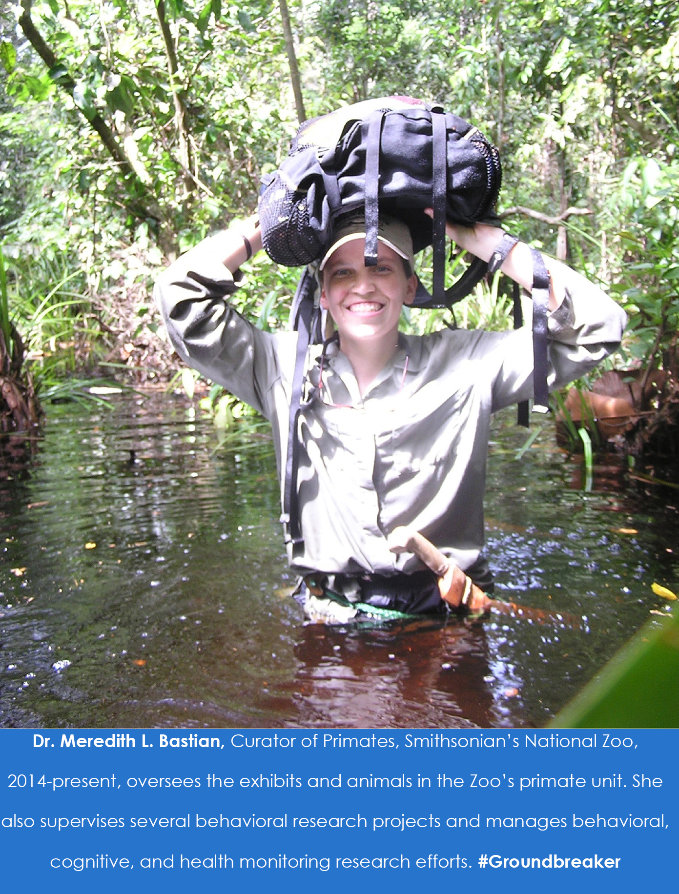 A person wades through water with a backpack over their head.