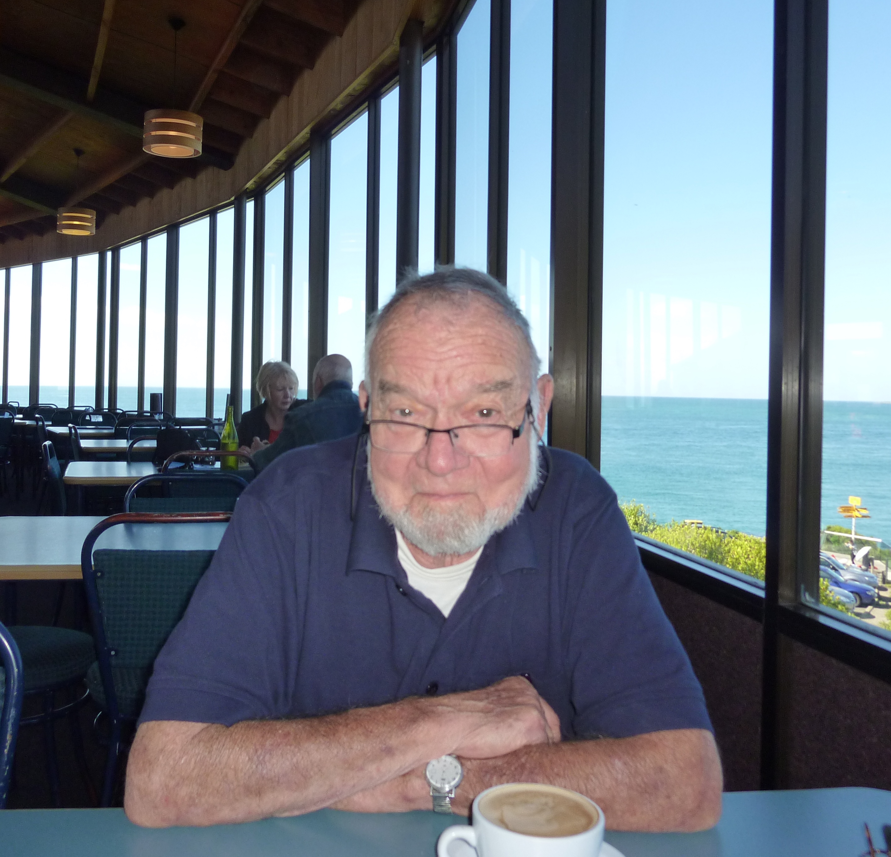 Color photo of Dr. Donald F. Squires, sitting in the Oyster Cove Restaurant.