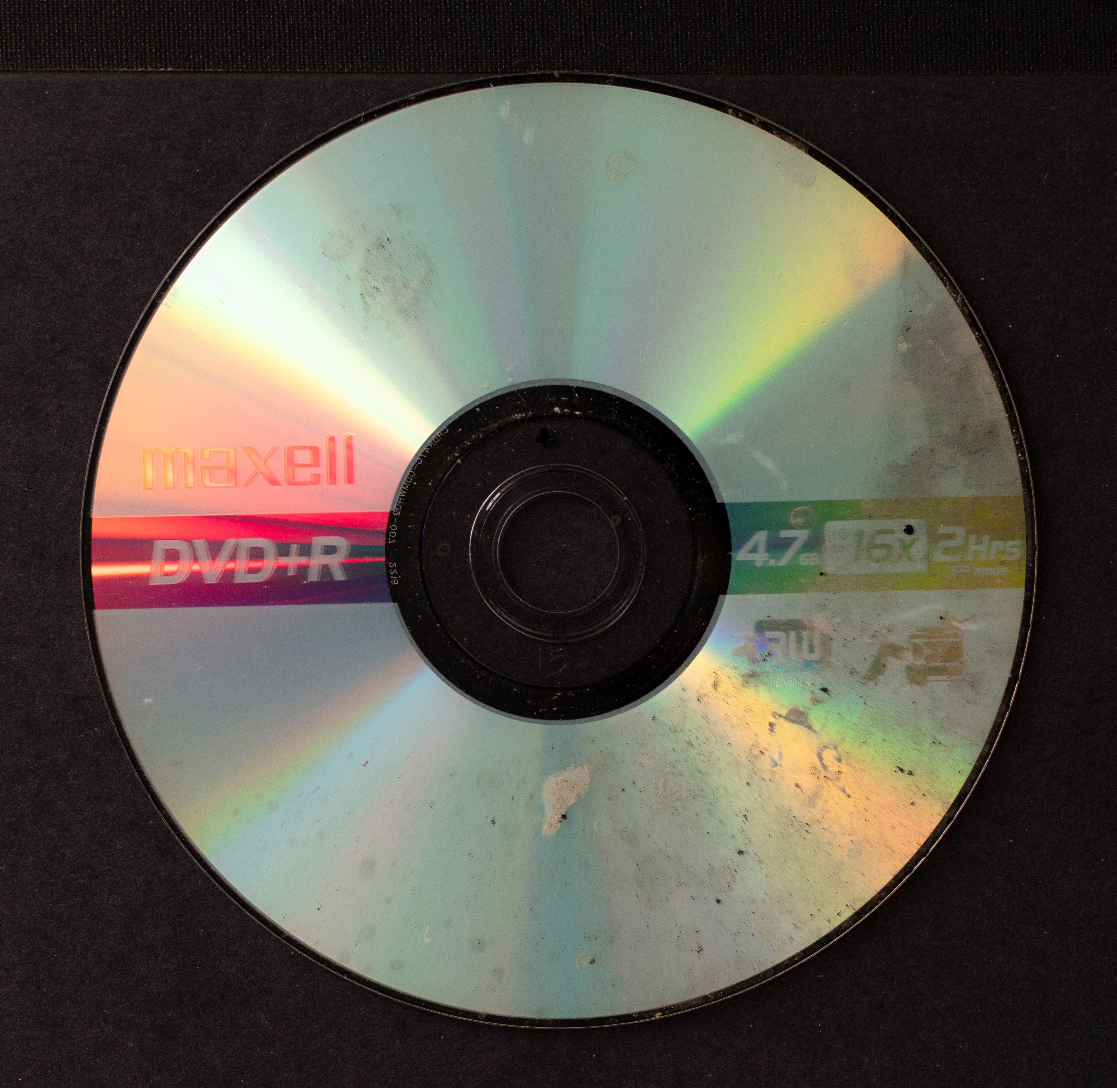 Water spots cover about half of the surface of the front side of a DVD.