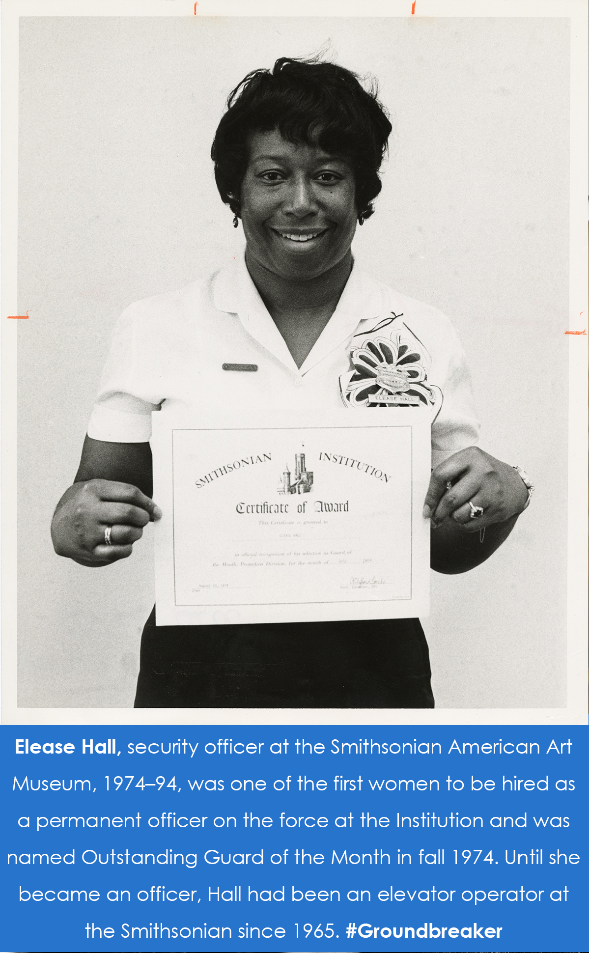 Hall holds up the Guard of the Month certificate. 