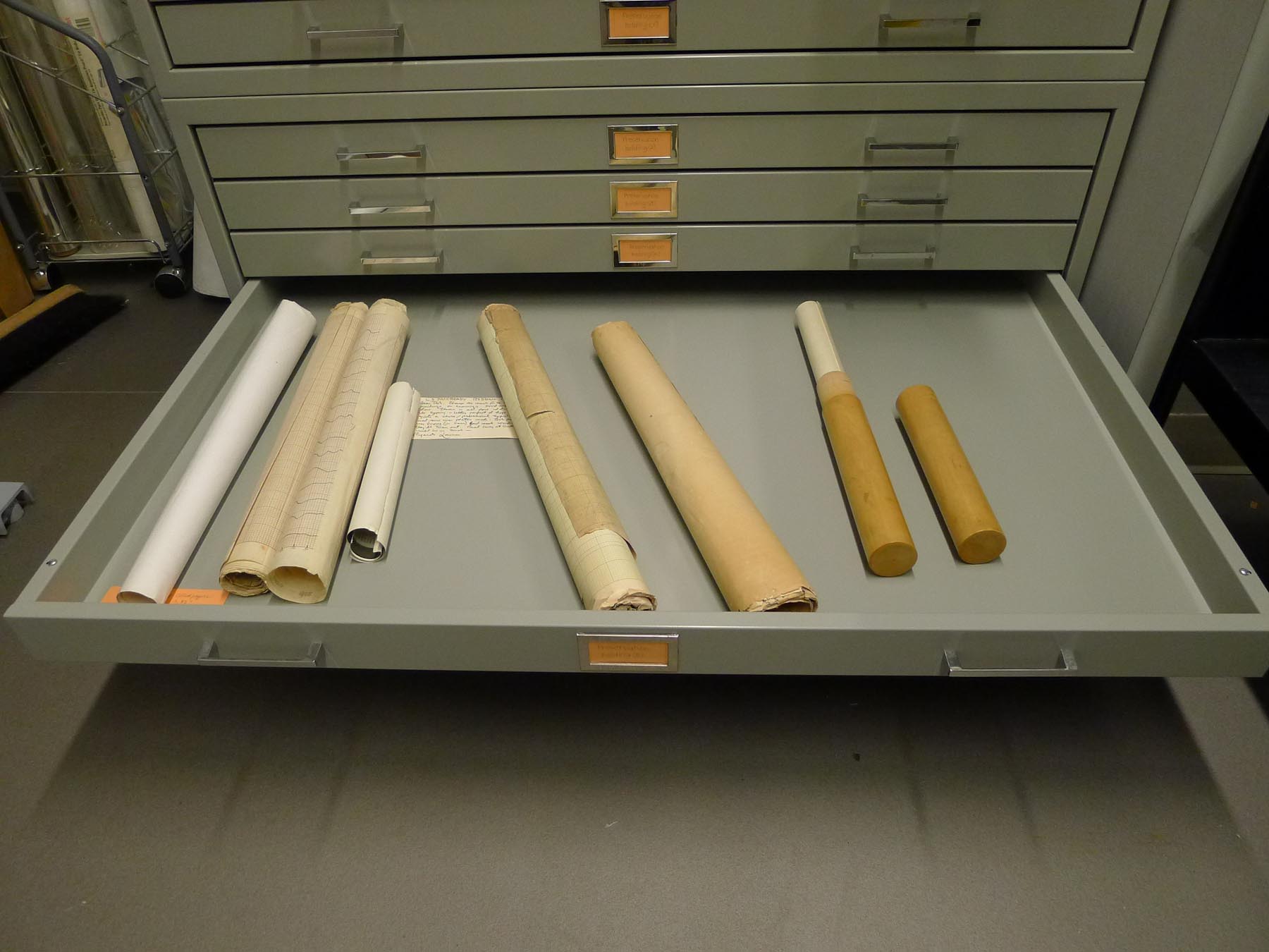 Rolled documents that need to be flattened.