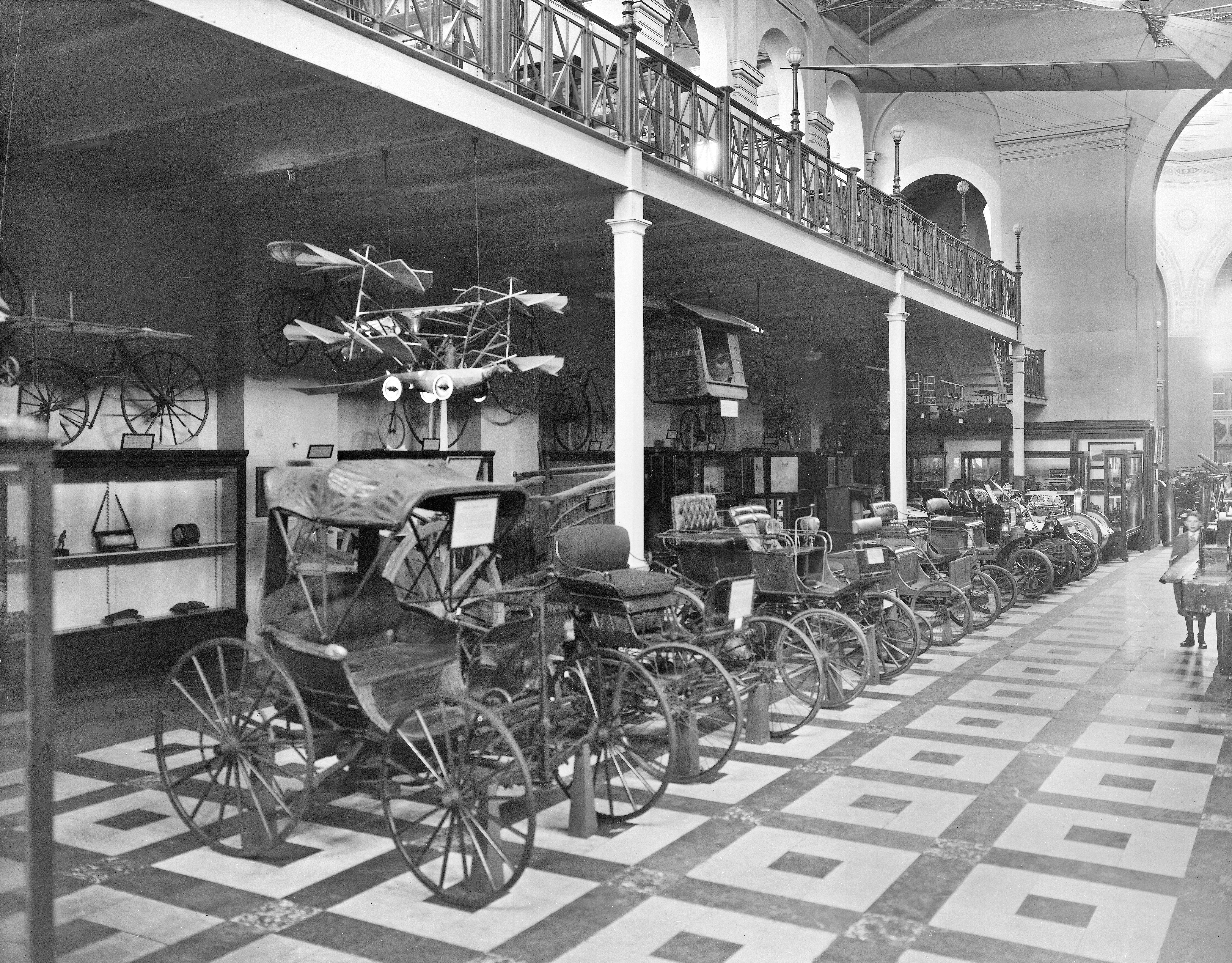 Transportation exhibit featuring automobiles in the United States National Museum, now known as the Arts and Industries Building, circa 1894.