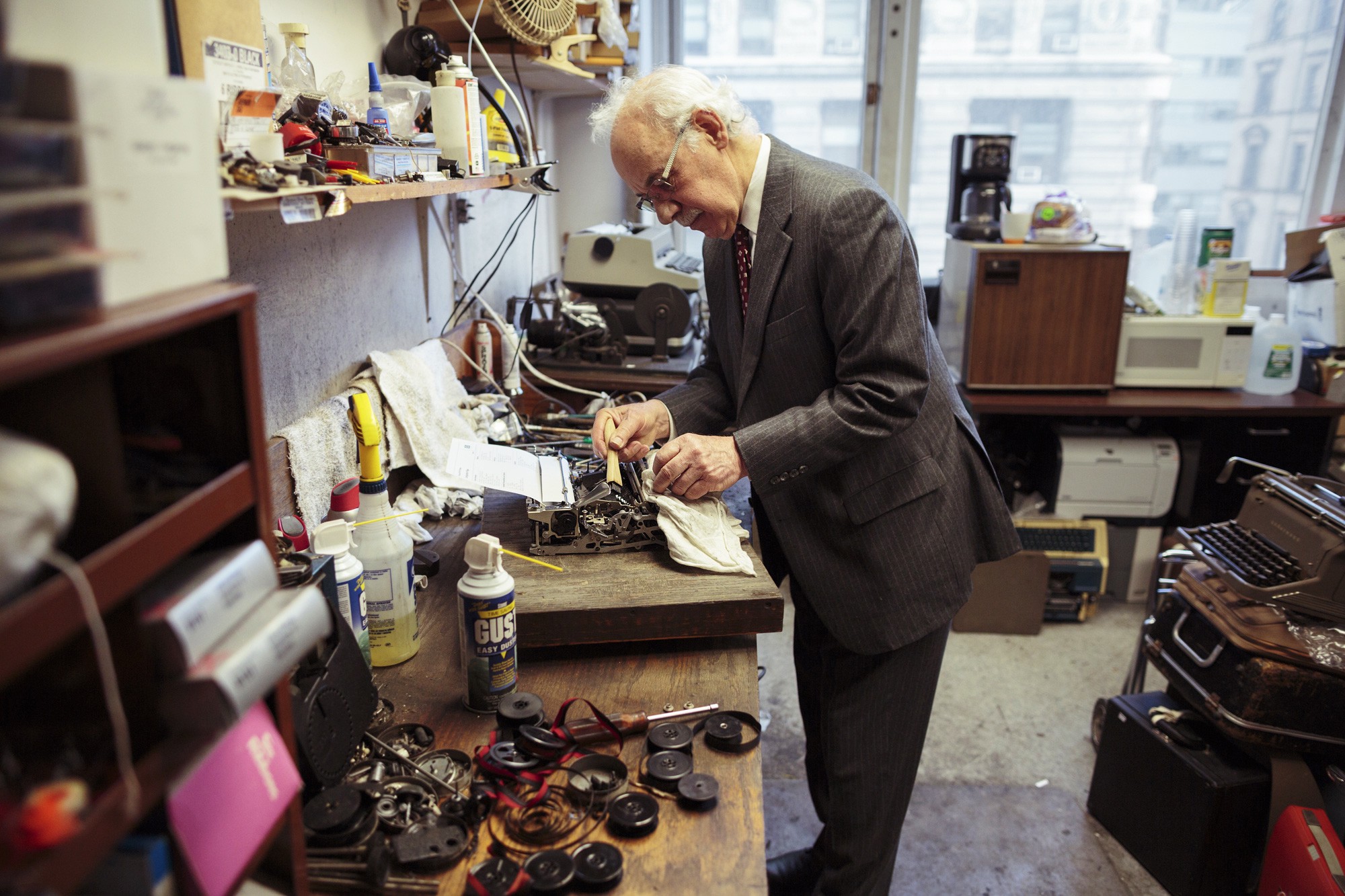 Paul Schweitzer repairing a typewriter, by Andrew White.