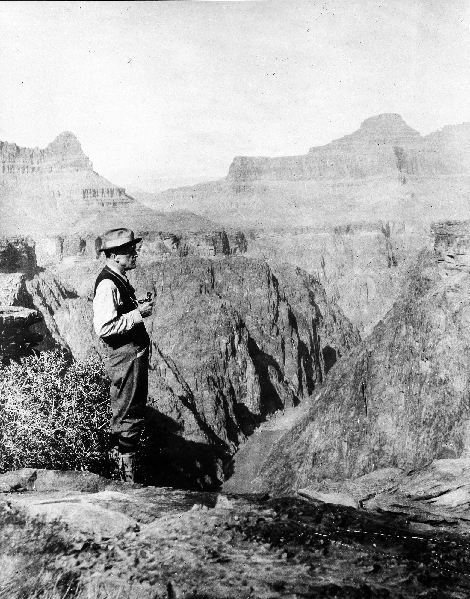 B&W image of man overlooking mountainous landscape.