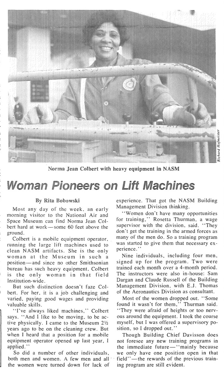 A photo of a woman smiling and operating heavy machinery at the Smithsonian