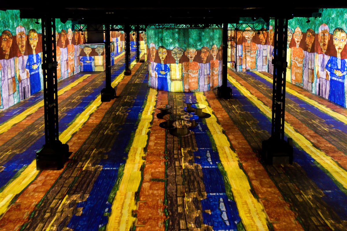 A large room with projections on the floor and walls with figure lining the side walls.