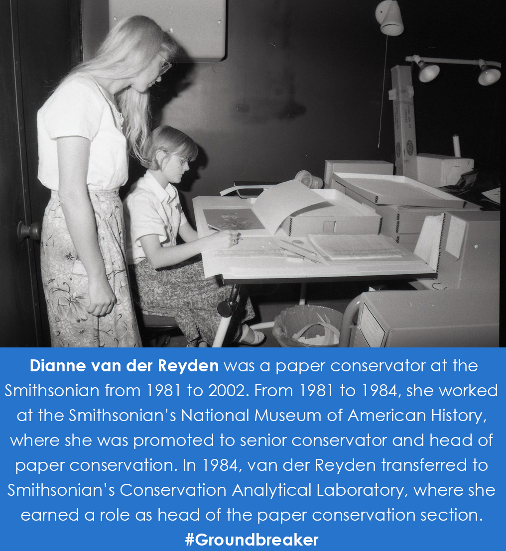 Van der Van der Reyden stands behind a conservator working on a document at a desk.