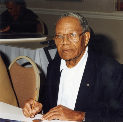 Louis R. Purnell sitting at a table, c. 1993, by Unidentified photographer, Color print, Smithsonian