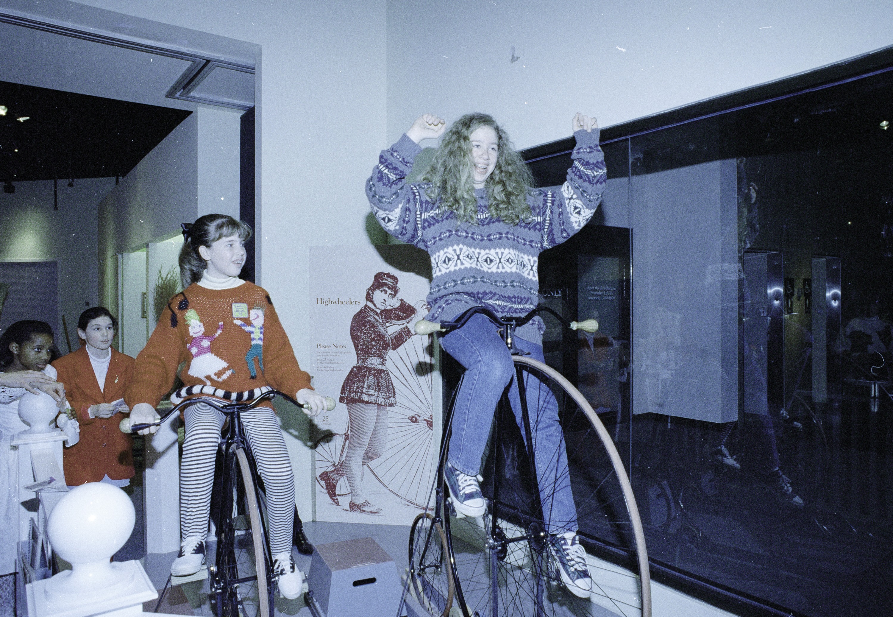 A boy and a girl harness a prop mule in an exhibit. The boy is in a wheelchair.