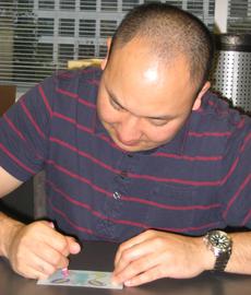 Mitch Toda puts the finishing touches on a fingerprint butterfly. Courtesy of Jennifer Wright.