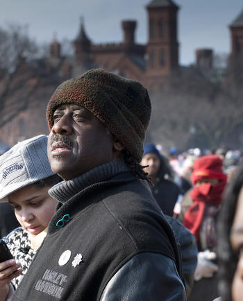 Inauguration visitor with Smithsonian Castle in background, January 20, 2009, by Michael Barnes, neg