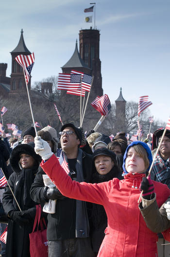 Inauguration visitors holding American flags in front of the Smithsonian Castle, January 20, 2009, b