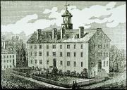 Five story symmetrical college building with four chimneys, a cupola on top and a front year with a 