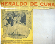 Image of Cuban newspaper, with black and white photographs of a ship and of men in back and white su