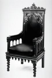 Black and white image of one of Renwick's armchairs with gothic carvings