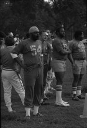 Smithsonian Institution flag football team stands on the sidelines during a game, 1980.