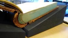 Close-up look at a heavy book with proper support, Smithsonian Institution Archives, 2014.