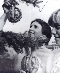 Smithsonian employees hanging Christmas ornaments, 1977