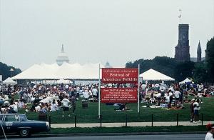 Image shows a crowded National Mall in Washington, D.C., for the Festival of American Folklife, with