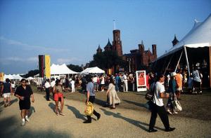 Image shows a close up of tents and people at the Festival of American Folklife, with the with the S