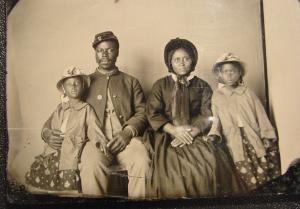 Unidentified African American soldier in Union uniform with wife and two daughters.