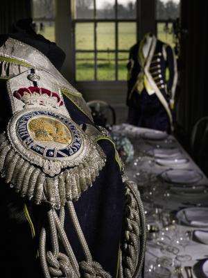 One of the livery uniform tailcoats, with epaulettes with silver-thread royal motto and coat of arms