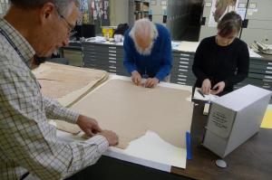 Volunteers Bob Demoyer (left), Jim Harle (center) apply skillful, reversible mends with guidance fro