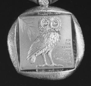 Square B&W image of a owl motif pendant.