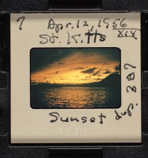 Film of sunset over water with white cardboard frame.