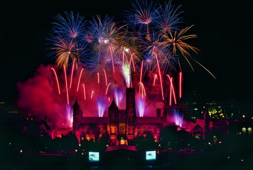 The Smithsonian Castle at night, August 10, 1996, with fireworks exploding off of the roof and tower