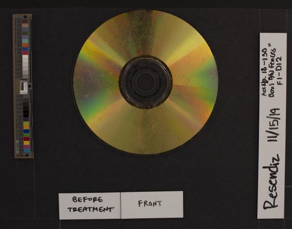 A dusty gold CD surrounded by a measurement scale and color card and object information labels.