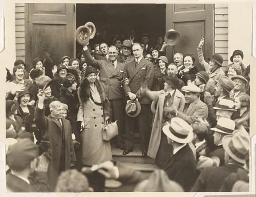 Roosevelt exiting building with his wife and son, applauded by citizens.