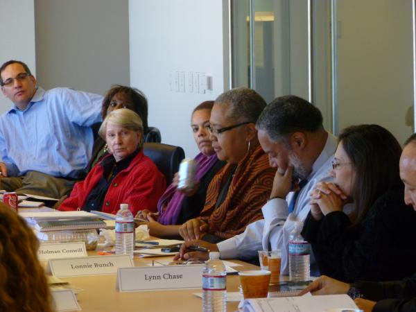 A group of people at a table discusses exhibit planning for National Museum of African American Hist