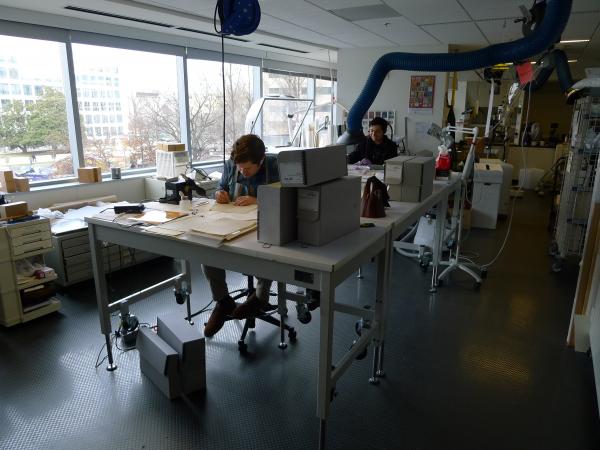 The blog author and another man sit at work stations in the conservation lab.