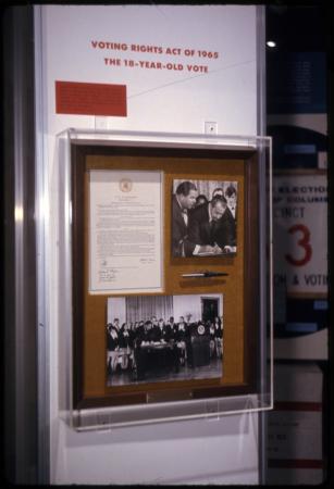 Pen on display alongside a document and a photograph of Nixon signing something. 