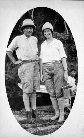 Lucile Mann, dressed in high socks, boots, and slacks, stands next to her husband in British Guiana 